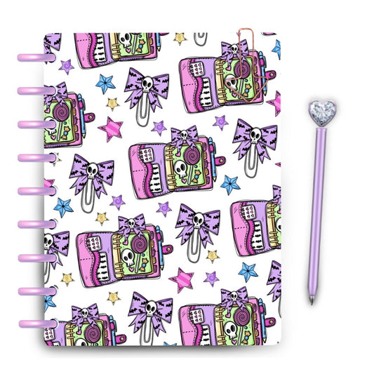 Pastel halloween laminated planner cover with skull bows and spooky cute planner spreads