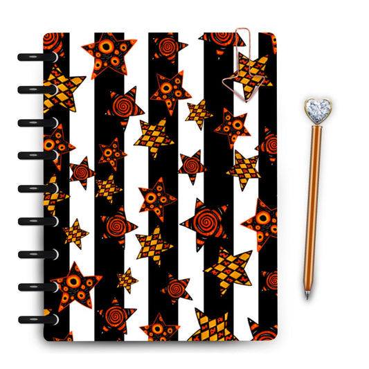 Black and white striped laminated planner cover with festive harlequin patterned stars throughout by magpiesoul