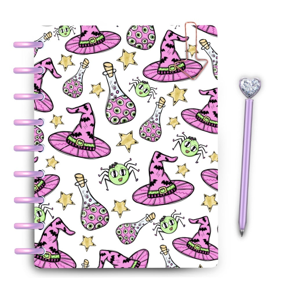 Pastel halloween witch hats, spiders & potion bottles on a white planner discbound cover